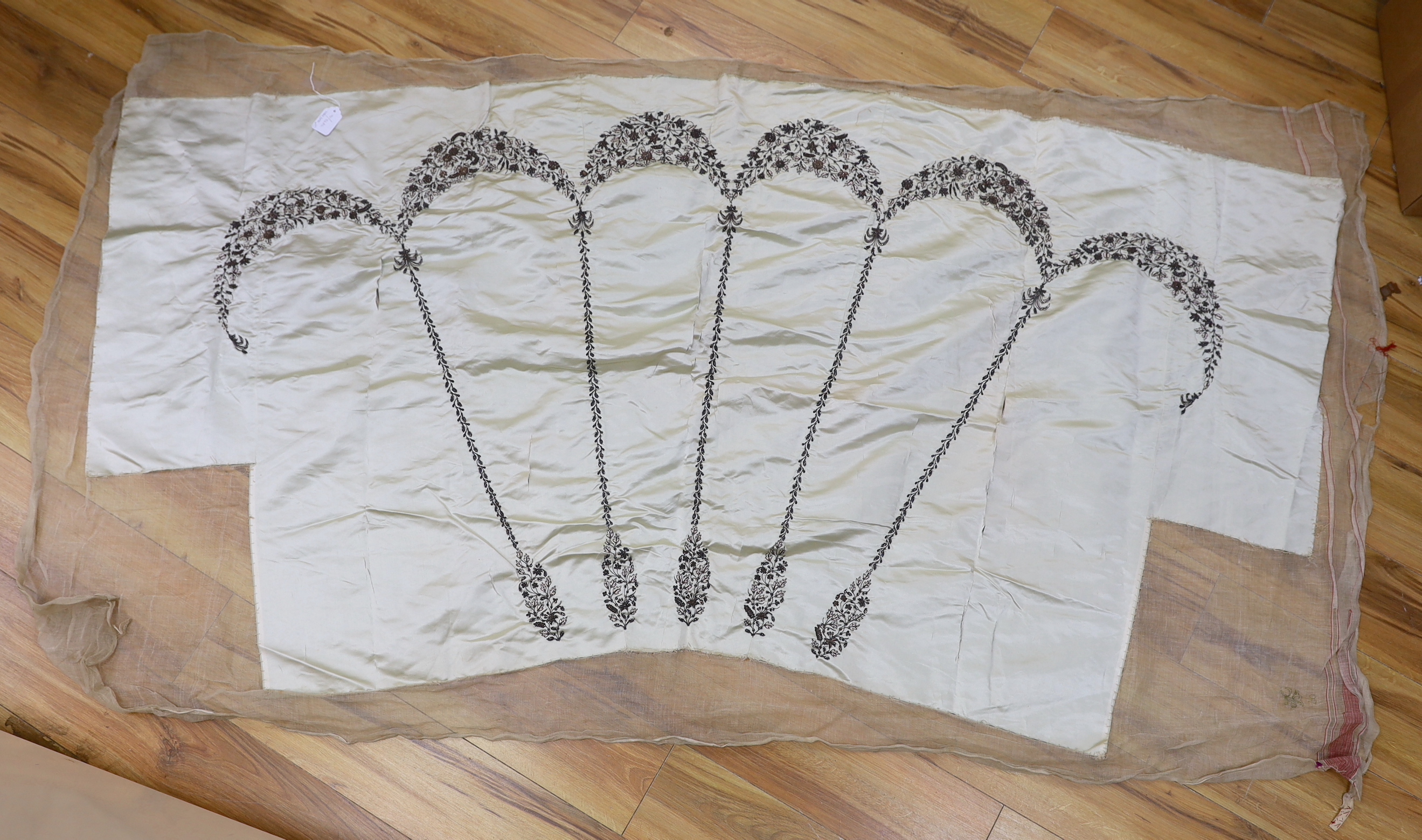 A 19th century pale green silk satin ladies dress skirt, embroidered into wide swags of silver metallic and pink threads